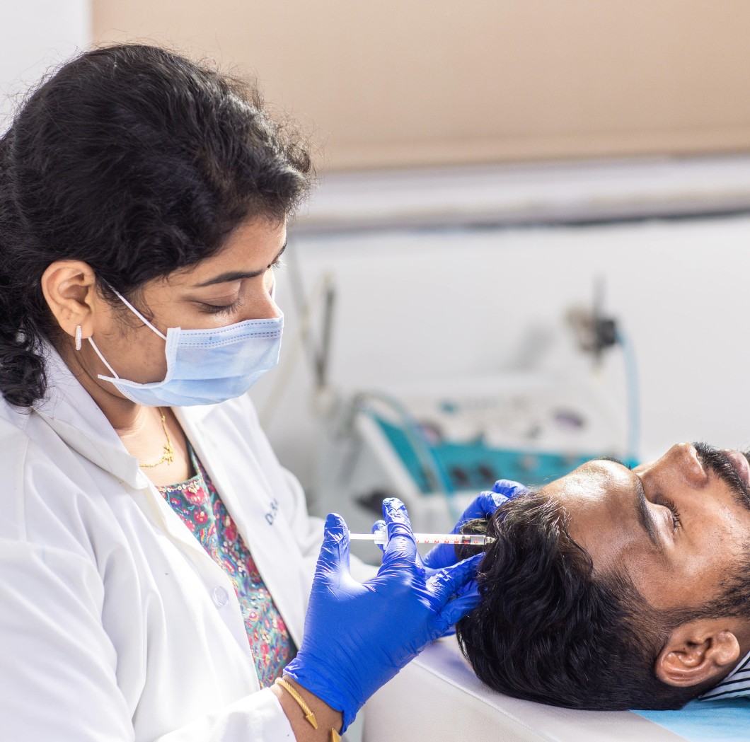 an image of Dr. Radha Panumatsa doing treatment to patient